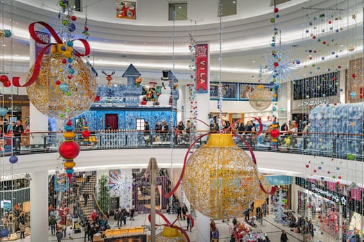 Dublin, November 2019 Large Christmas balls and decorations in Jervis Shopping Centre with Santa Claus grotto in background