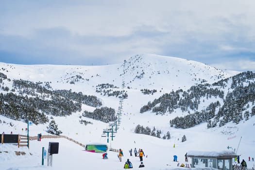 El Tarter, Andorra, January 2020 Group of people, skiers and snowboarders taking on ski lift in Pyrenees Mountains, Grandvalira