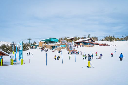 El Tarter, Andorra, Jan 2020 Group of people, families, skiers and snowboarders taking on ski lifts and having fun in Pyrenees Mountains, Grandvalira