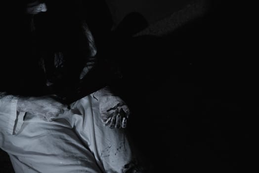 Woman ghost horror sitting her have knife arm in the house, halloween concept