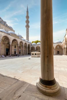 Istanbul, Turkey - August 26, 2022: Courtyard of Suleymaniye Mosque with few tourists walking around, an Ottoman imperial mosque located on the Third Hill of Istanbul