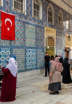 Istanbul, Turkey - September 1 2022: People praying in front of the tomb of Abu Ayyub al-Ansari at Eyup Sultan Mosque