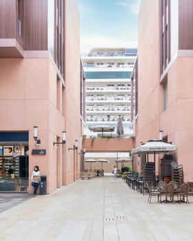 Istanbul, Turkey - August 31, 2022: Internal passage at Galataport, a mixed use development located along shore of Bosphorus strait, in Karakoy district, with docked huge cruise ship in the background
