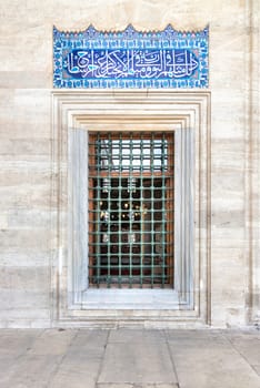 Decorated wrought iron window, in a stone wall, at the courtyard of Suleymaniye Mosque, Istanbul, Turkey