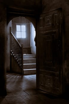 A wooden door leading to a mall door leading to the roof of an old historic house in Old Cairo, Egypt