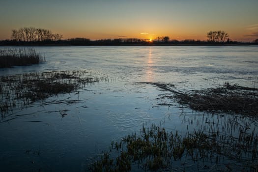 Evening view of an icy lake during sunset, Stankow, Lubelskie, Poland