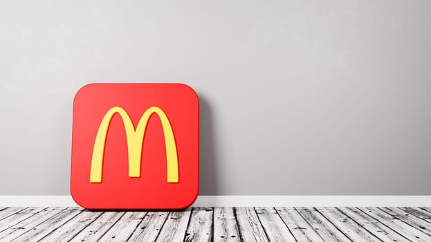 Mcdonalds Logo 3D Symbol Shape on Wooden Floor Against Gray Wall with Copy Space 3D Render Illustration
