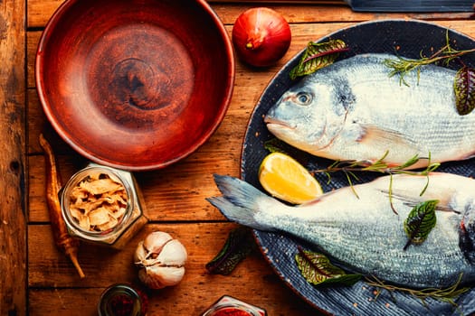 Two raw dorado fish for cooking on a plate. Seafood
