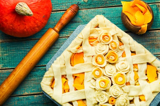Making traditional pumpkin pie, raw pie.Rustic table