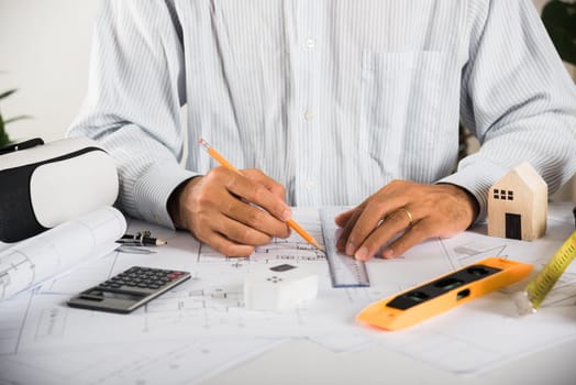 Architect workplace. Architectural building design and construction plans with blueprints paper project plans VR glasses, designing man edit a building or architecture with ruler, technology industry