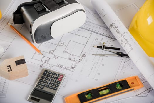 Architect workplace top view. Architectural blueprint paper project plans on desk table, tool for engineer contractor building design working drawing and VR glasses, industry virtual technology