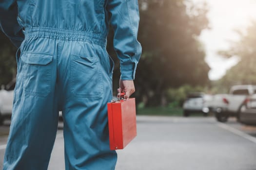 Back mechanic man maintenance with tools togo service repair outdoor, Closeup of professional technician come to checking condition of car, The auto mechanic works car broken outside