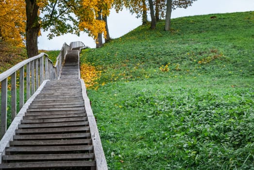 Steps of a high wooden staircase leading to Dubingiai Hill, Lithuania.