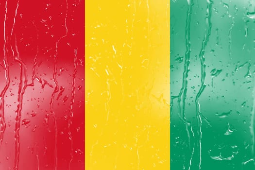 3D Flag of Guinea on a glass with water drop background.