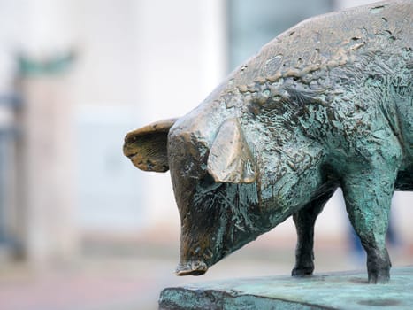 Pig as a bronze statue on the canal bridge in the city of Wismar.