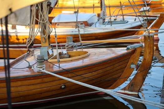 Details of a sailboat which is anchored in the harbor.
