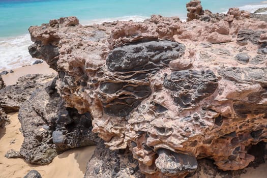 A rock with inclusions. Origin is volcanic activity.