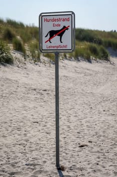 On one beach, a sign marks the "end of dog beach, leash required"" from then on."