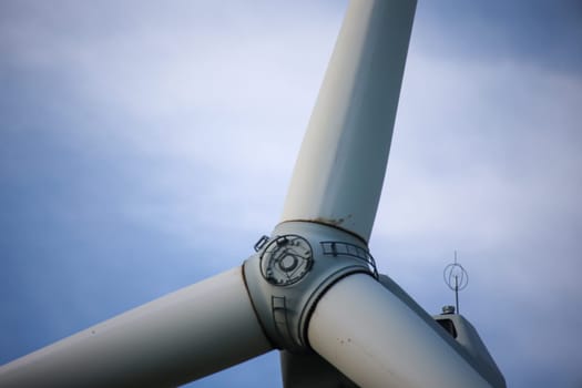 Close-up of the hub of a wind turbine. Blade and hub of a wind turbine.