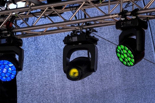 Spotlights for the illumination of a stage hang on a mounting scaffold.