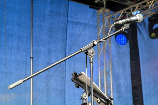 On a stage there is a microphone unused during a break.