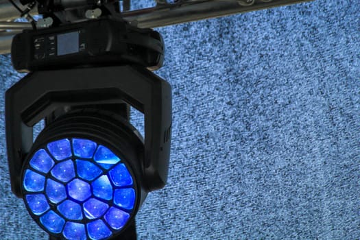 Spotlights for the illumination of a stage hang on a mounting scaffold.