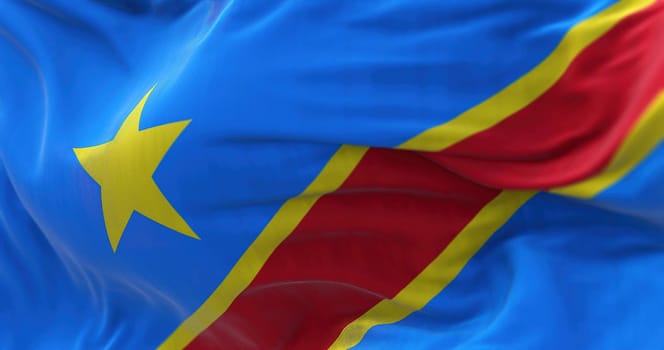 Close-up view of The Congo national flag waving in the wind. The Democratic Republic of the Congo is a State of Central Africa. Fabric textured background. Selective focus