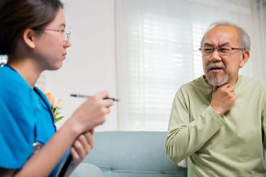 Asian young nurse checking senior man neck pain in clinic at retirement home, doctor woman examines lymph nodes on neck to determine if swollen, sore throat