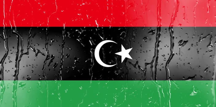 3D Flag of Libya on a glass with water drop background.