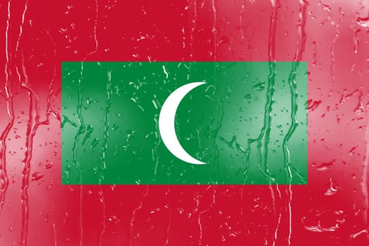 3D Flag of Maldives on a glass with water drop background.