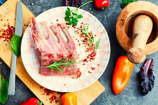 Appetizing raw lamb rib and spices on the kitchen table.