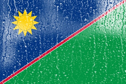 3D Flag of Namibia on a glass with water drop background.