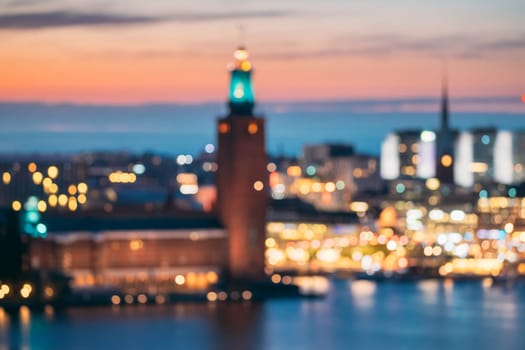 Stockholm, Sweden. Night Skyline Abstract Boke Bokeh Background. Design Backdrop. Tower Of Stockholm City Hall.