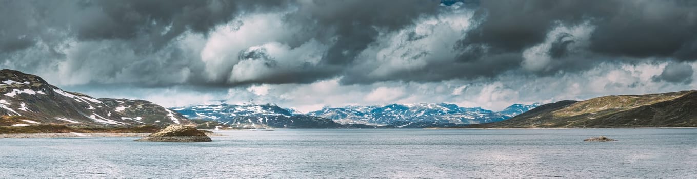 Oppland, Tyin Lake, Norway. Stones On Coast Of Beautiful Lake Tyin In Summer Cloudy Day. Norwegian Nature. panorama, panoramic view