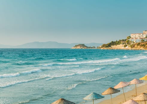 Umbrellas On Sea Beach. Vacation. Riplpe Sea Ocean Water Surface With Small Waves