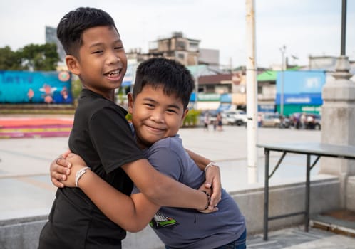 Brothers hugging each other and smiling happily