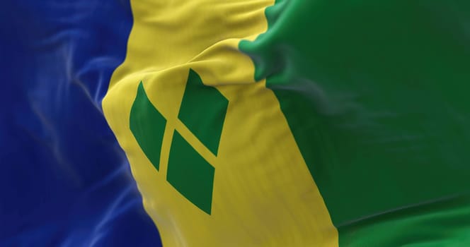 Close-up view of Saint Vincent and the Grenadines national flag waving. Fabric textured background. Selective focus