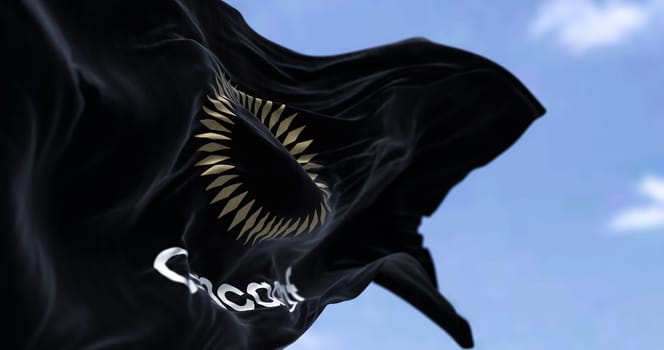 Miami, USA, October 2022: The black flag with the CONCACAF logo waving in the wind on a clear day. CONCACAF is the football government of North America, Central America and the Caribbean.