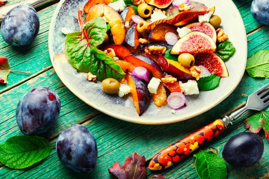 Autumn salad with figs, plums, herbs and olives.