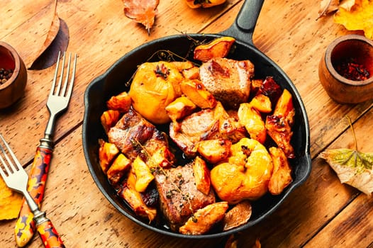 Delicious meat cooked with autumn fruits on the plate