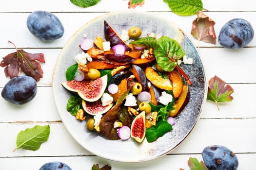 Autumn salad with figs, plums, herbs and olives.