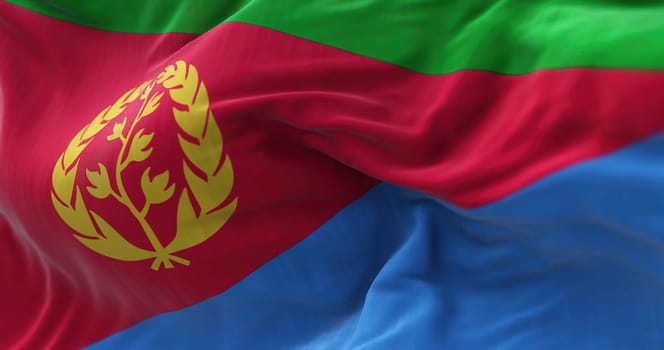 Close-up view of the Eritrea national flag waving in the wind. The State of Eritrea is a State located in the northern part of the Horn of Africa. Fabric textured background. Selective focus