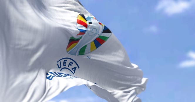 Berlin, Ger, October 2022: Rear view of UEFA Euro 2024 flag flying in the wind. The 17th edition will take place from 14 June to 14 July 2024 in Germany. Selective focus. International sport event