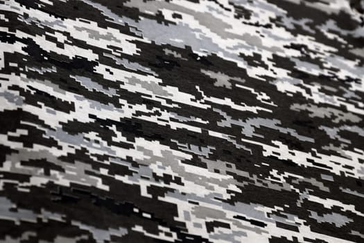 Fabric with texture of Ukrainian military pixeled camouflage. Cloth with camo pattern in grey, brown and green pixel shapes. Official uniform of Ukrainian soldiers close up
