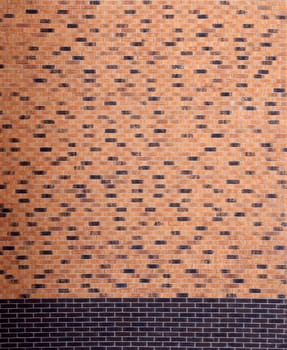 Dark brick wall pattern with chaotic masonry order. Background texture or resource for 3d texturing. Many bricks in big modern stone wall in full frame.