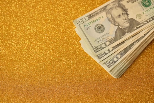 Big amount of old twenty dollar bills on golden background. Money earnings, payday or tax paying period concept