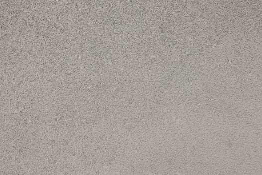 Grungy white concrete wall background. Rough stucco technique in full frame. Detailed texture daytime backdrop