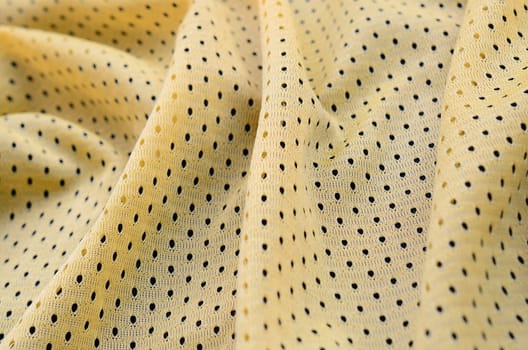Yellow sport jersey clothing fabric texture and background with many folds