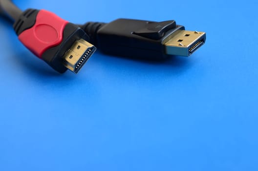 Audio video HDMI computer cable plug and 20-pin male DisplayPort gold plated connector for a flawless connection on a blue background