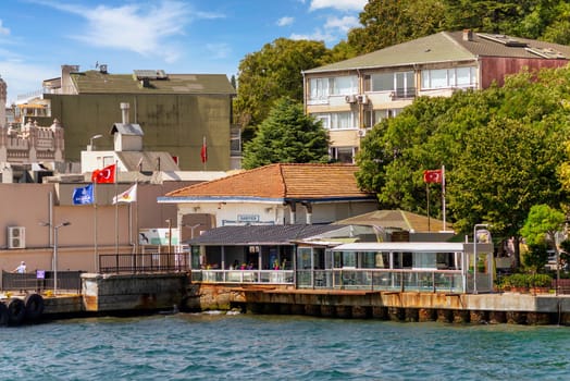 Istanbul, Turkey - August 29, 2022: Bosphorus Strait, Sariyer Ferry Terminal with dense green trees in the background